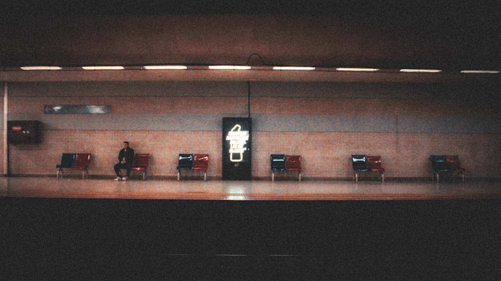 a person sitting on a bench in a room