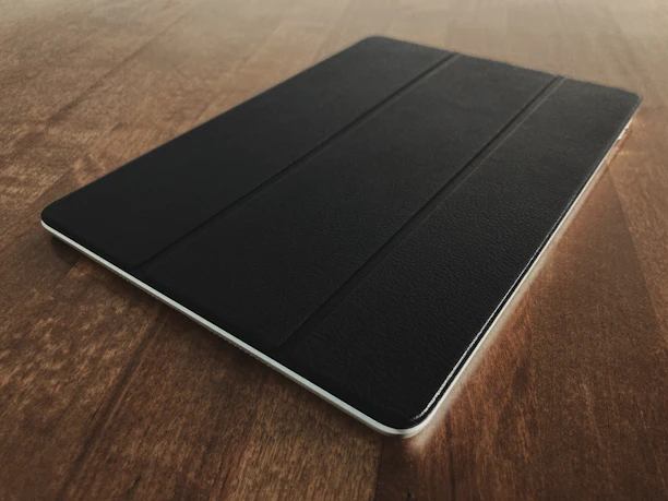 Modern tablet resting on a clean gray surface with subtle shadows.