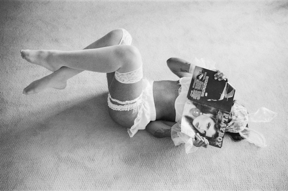 a woman laying on the floor with her legs crossed