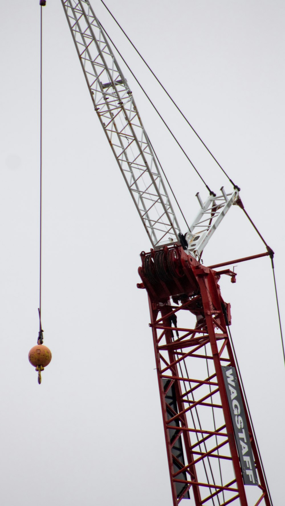 a crane is lifting a ball into the air