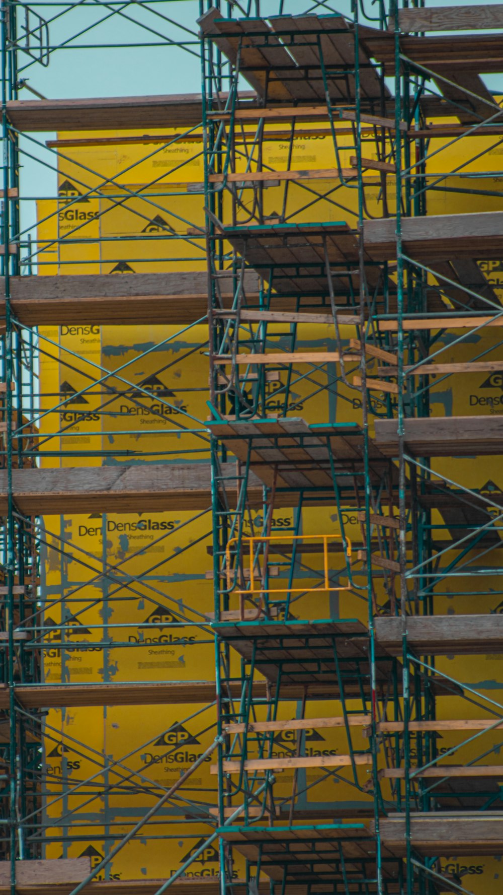 a large yellow building with lots of scaffolding