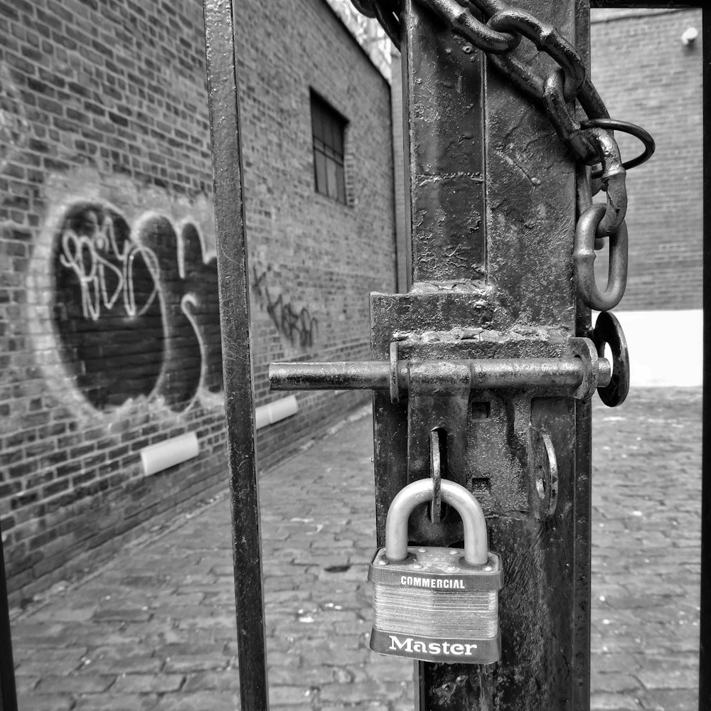 a padlock is attached to a metal pole