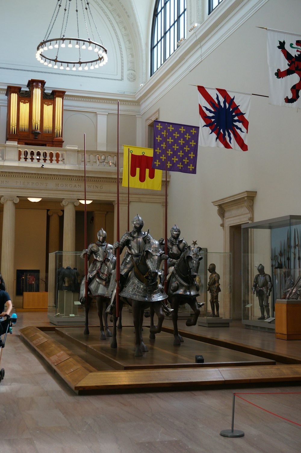 a group of statues of knights in a museum