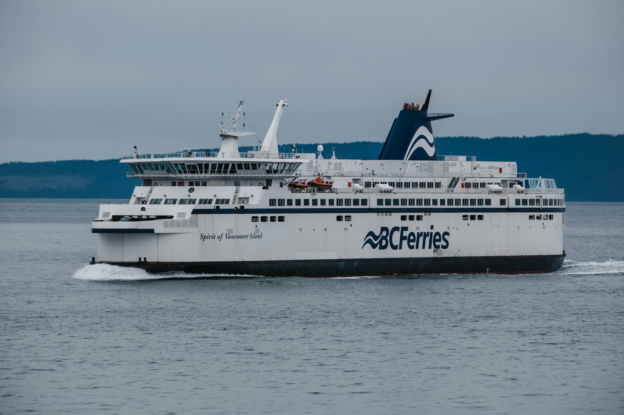a large white boat traveling across a large body of water