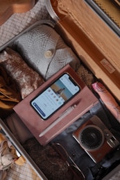 A laptop screen showing flight options and a packed suitcase ready to go.
