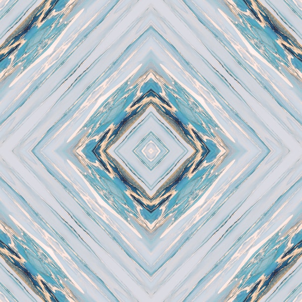 A digital artwork featuring a symmetrical geometric pattern with diamond shapes. The design has a kaleidoscopic effect with various shades of blue, pale yellow, and cream intertwining across the canvas, creating a visually compelling abstract look.