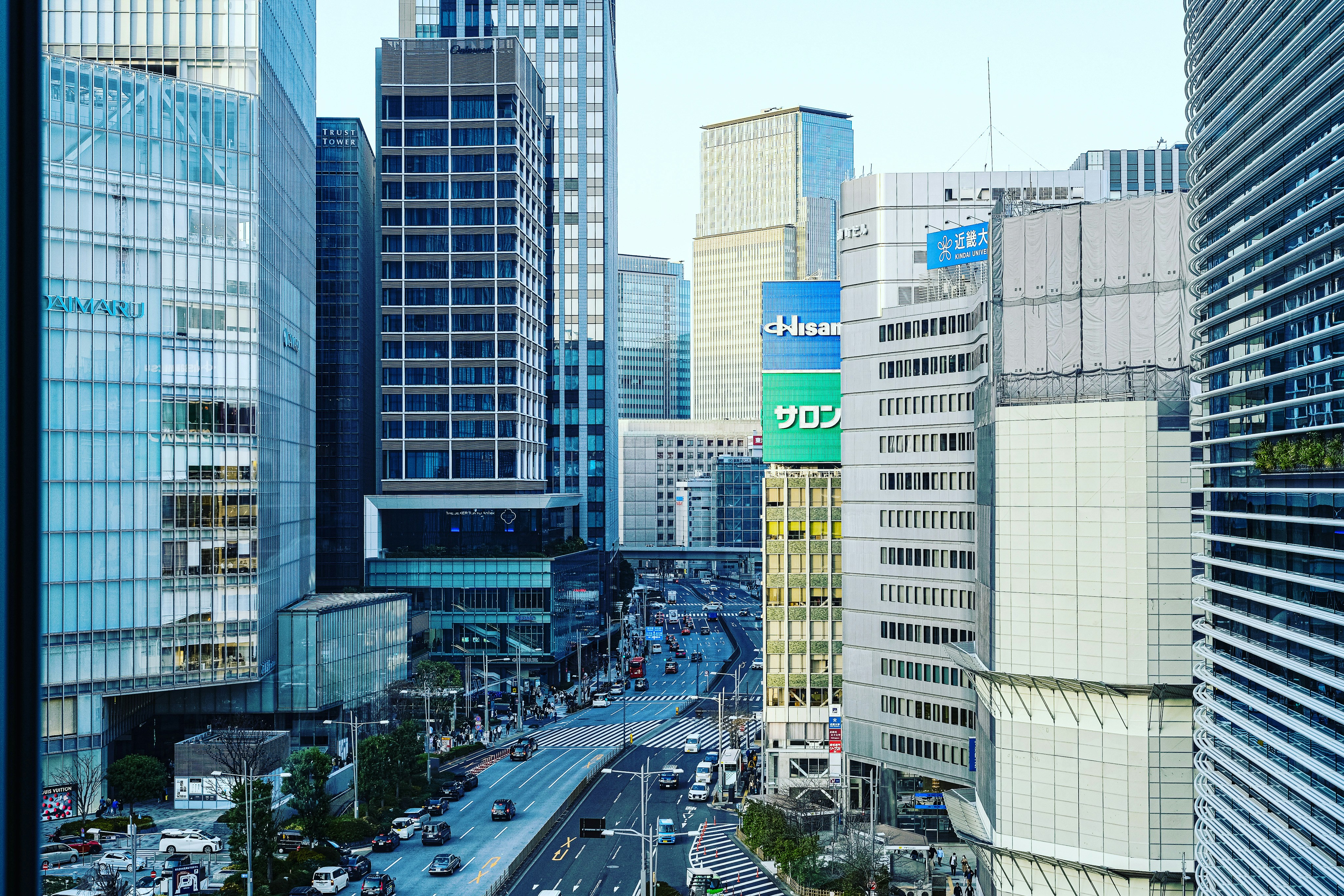 a view of a busy city street with tall buildings