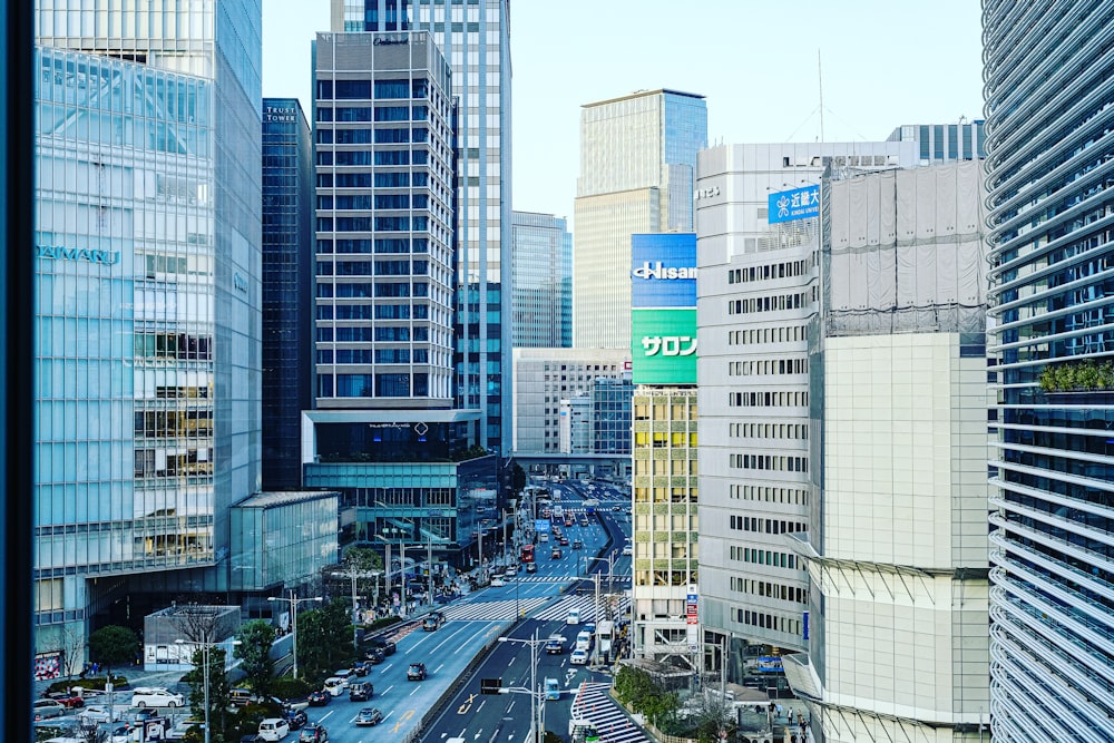 a view of a busy city street with tall buildings
