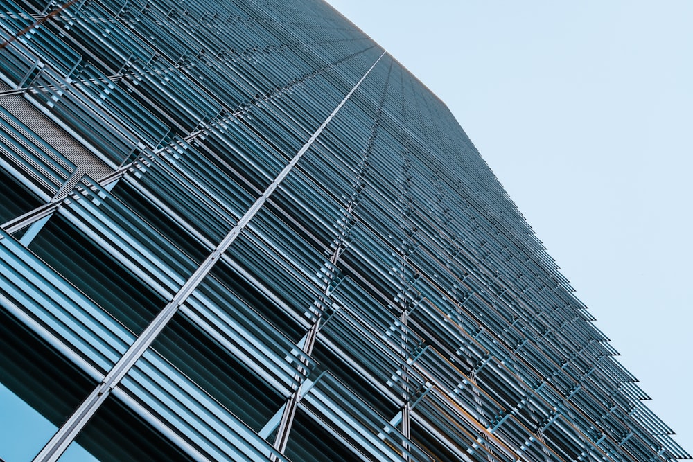 a tall building with many windows and a sky background