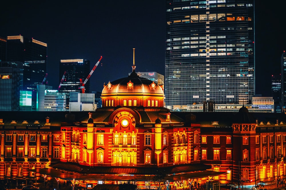 a large building lit up at night in the city