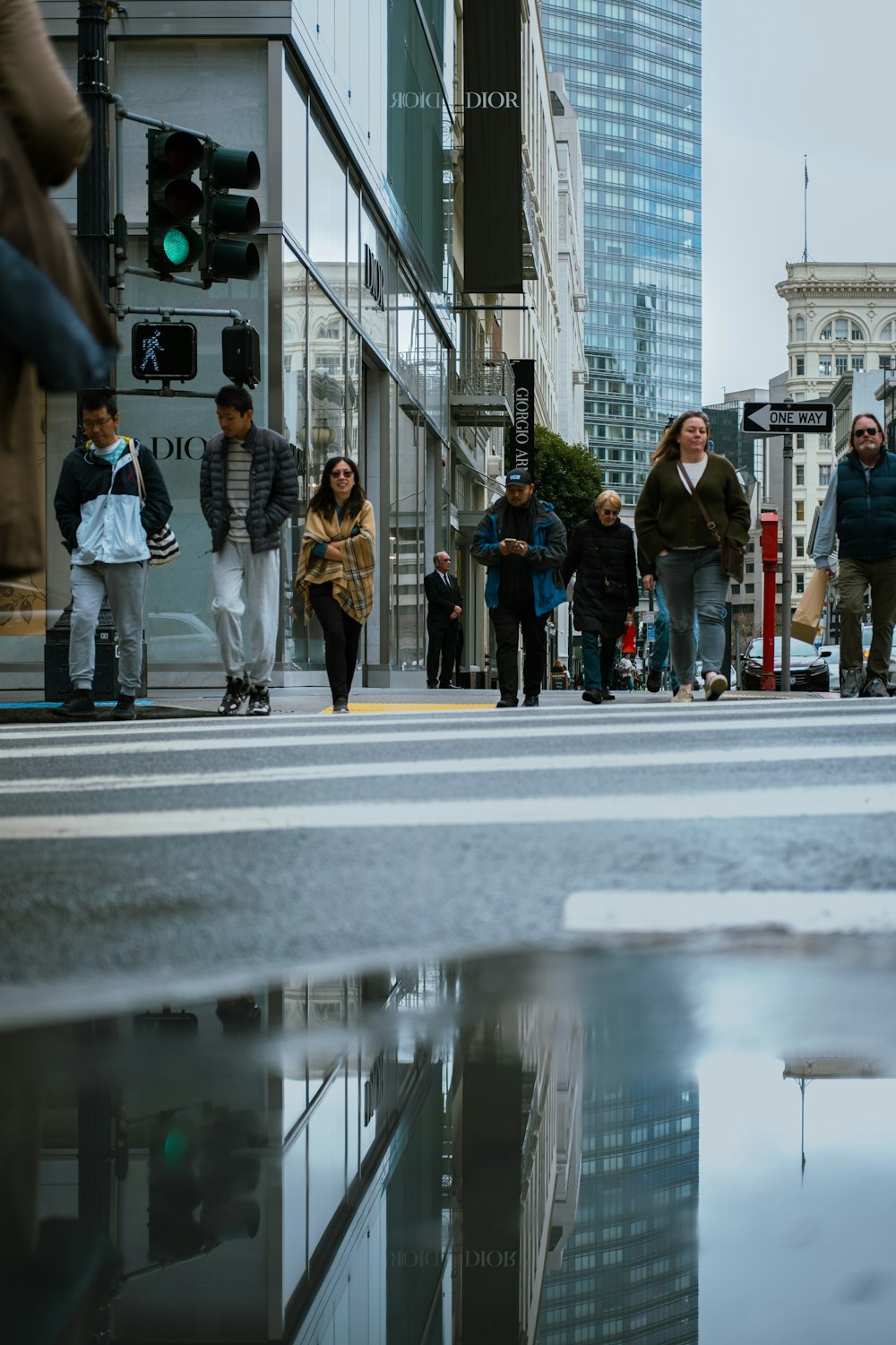 a group of people walking across a street