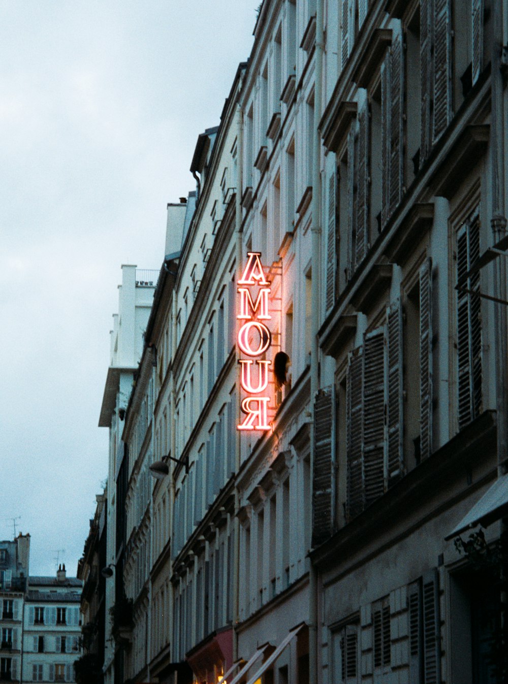 a neon sign on the side of a building