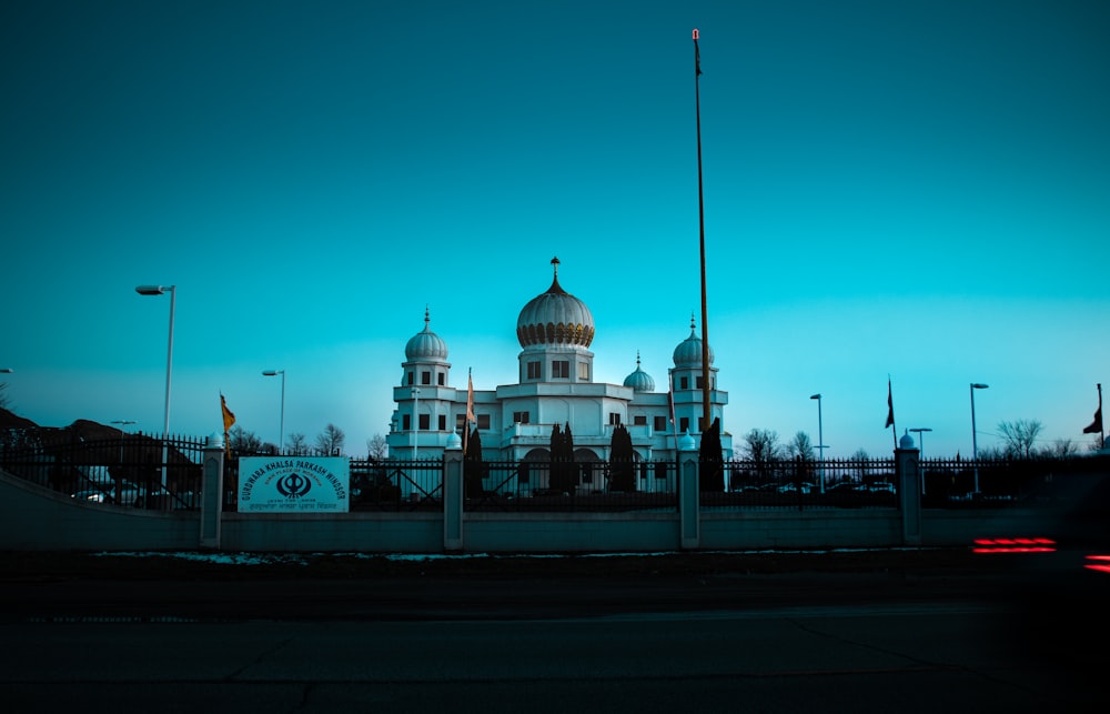 a large white building with a clock on it's side