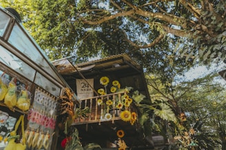 a building with sunflowers hanging from it's balconies