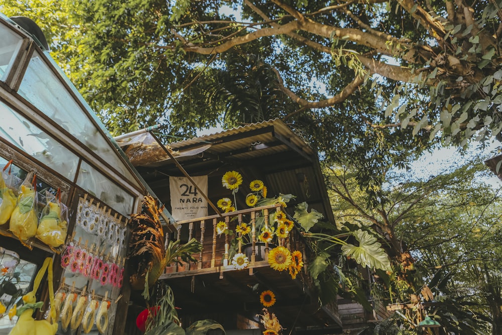 a building with sunflowers hanging from it's balconies