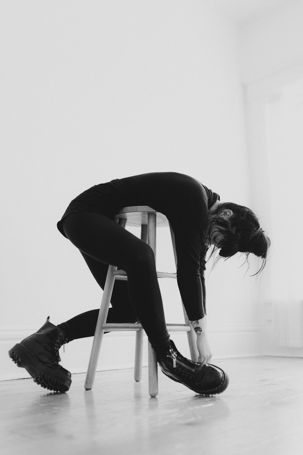 a woman sitting on a stool in a room