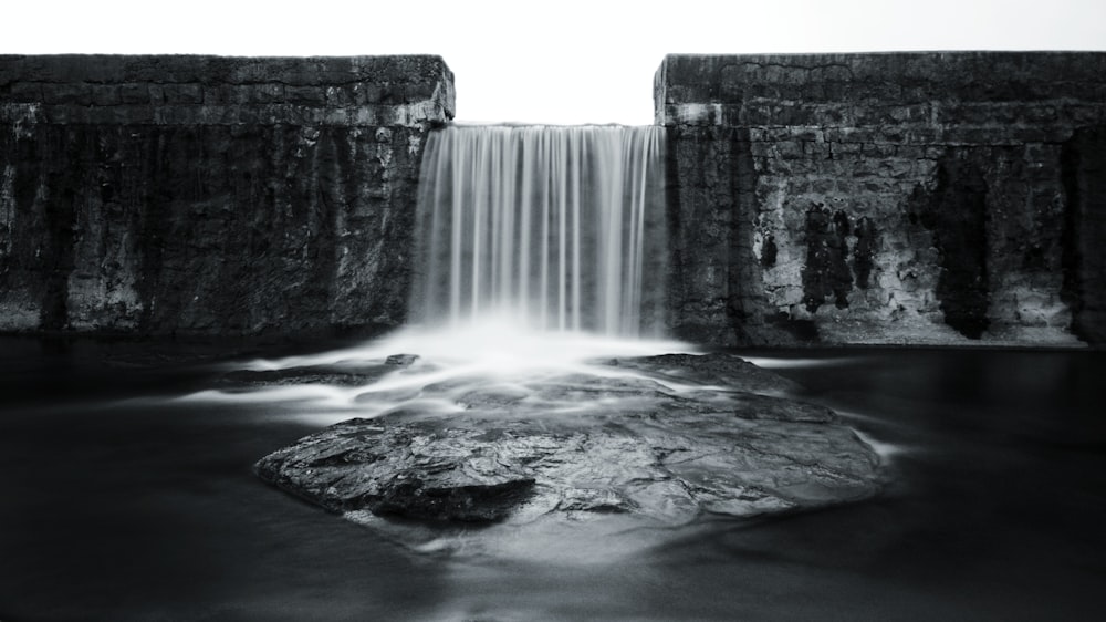 a black and white photo of a waterfall