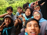 An outdoor scene with friends taking selfies together.