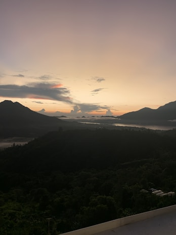 A serene view of a lush Sri Lankan landscape at sunset.