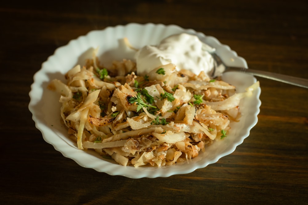 a white bowl filled with food on top of a wooden table