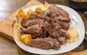 a white plate topped with steak and potatoes