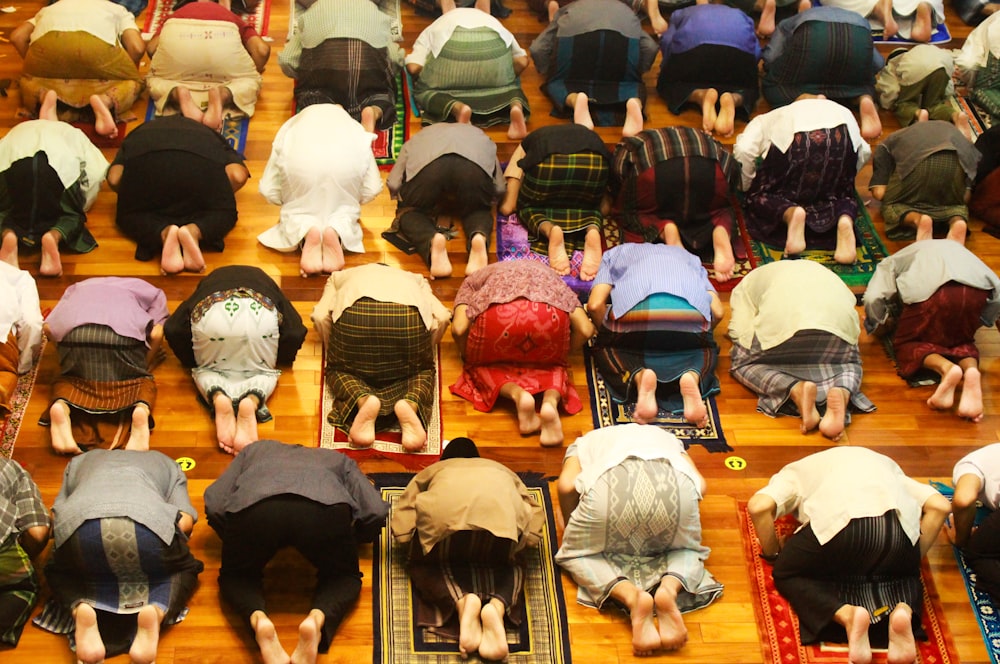 a group of people laying on a rug in a room