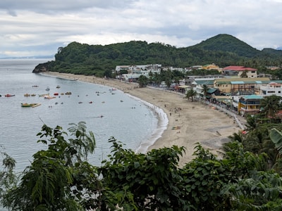 Scenic view of Florianópolis coastline with tourists walking along the shore