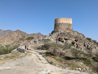 Galen and his companions standing united on a hilltop, looking toward the distant silhouette of the One Tower.