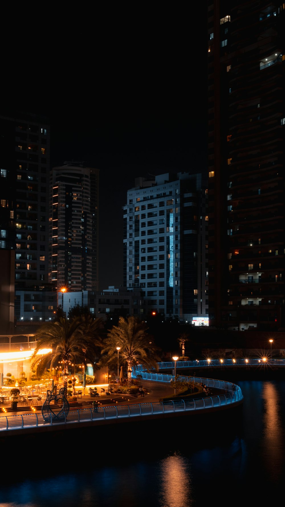 a city at night with a river running through it