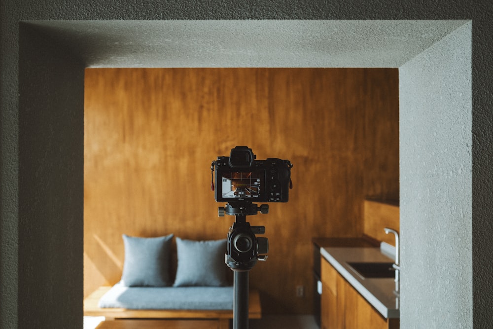 a camera is on a tripod in a room