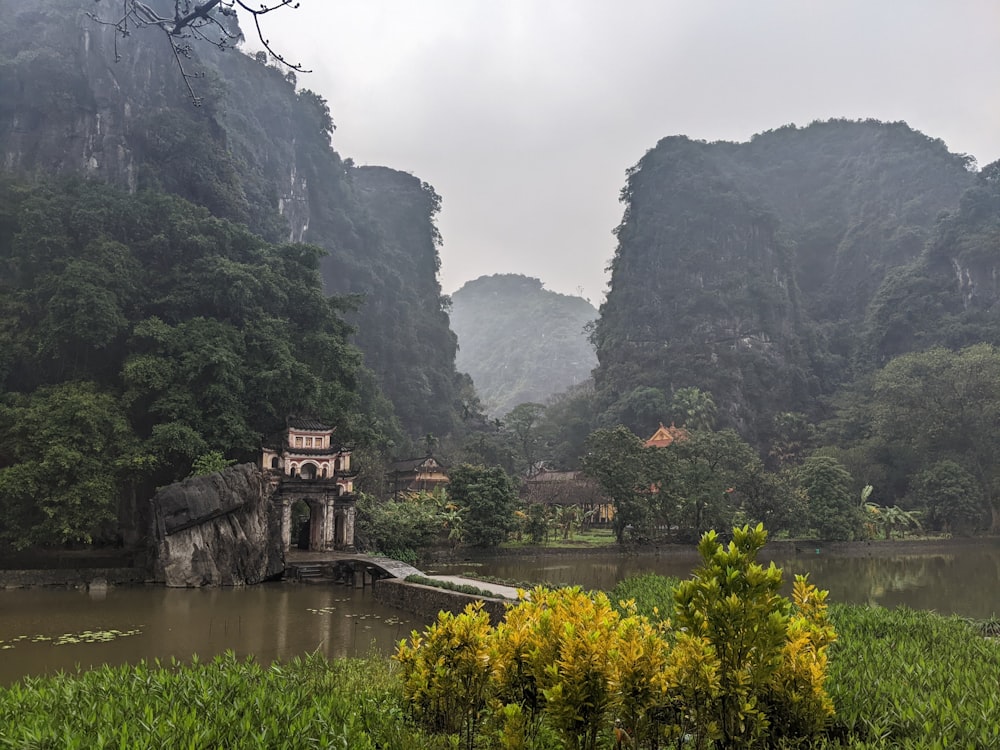 a lake surrounded by mountains in the middle of a forest