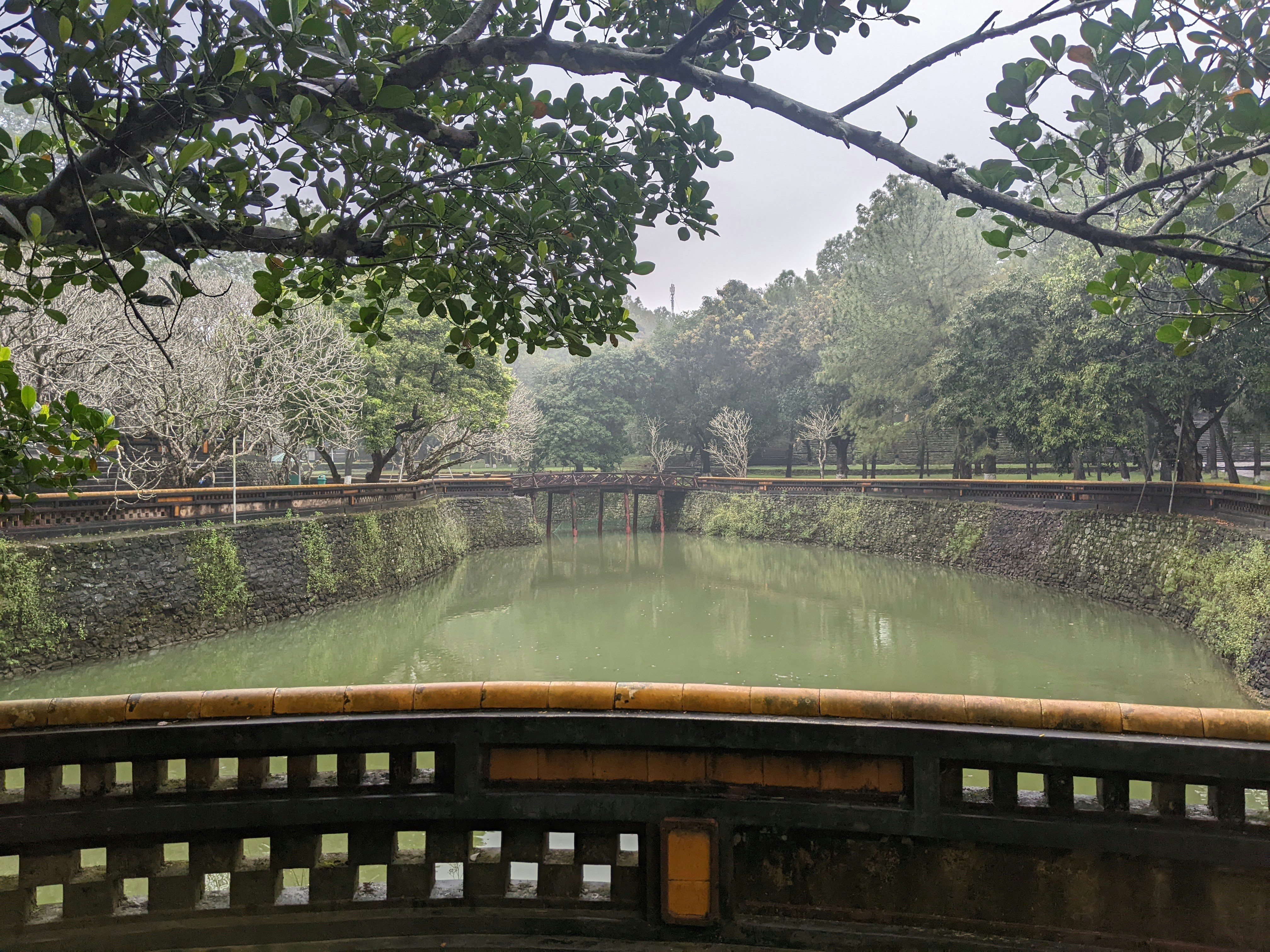 a bridge over a river surrounded by trees