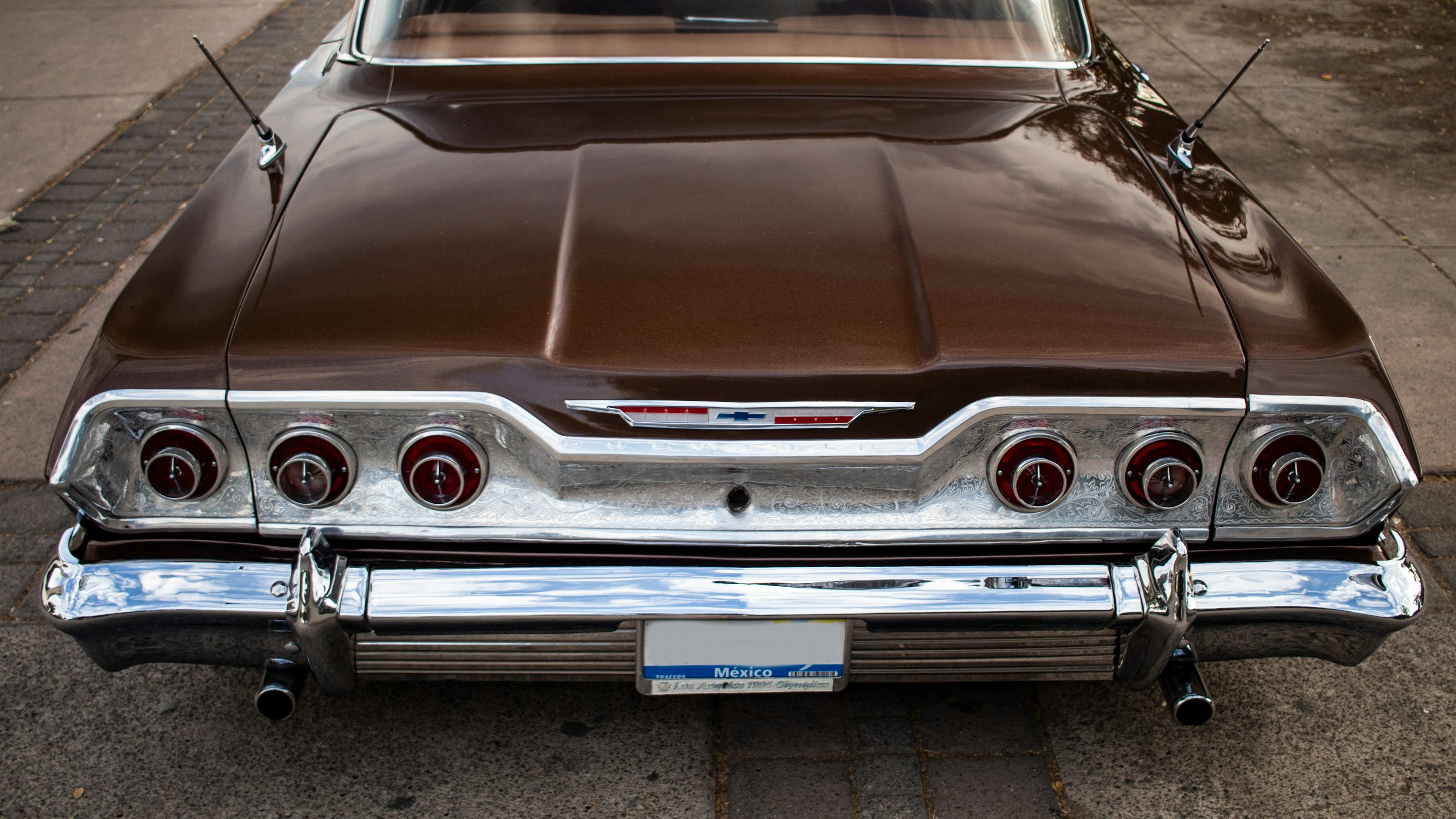 a brown car parked on the side of the road