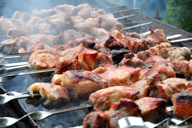 a bunch of meat is cooking on a grill