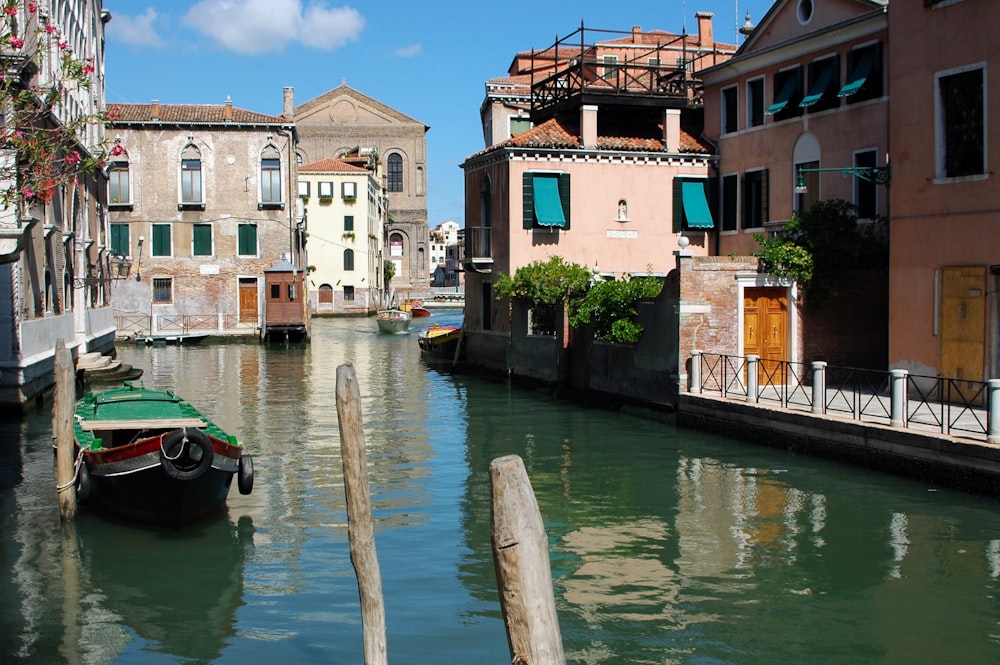 a small boat is in the middle of a canal