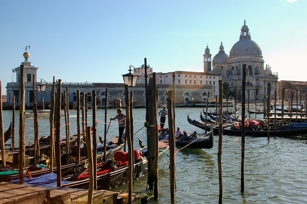 a bunch of gondolas that are sitting in the water