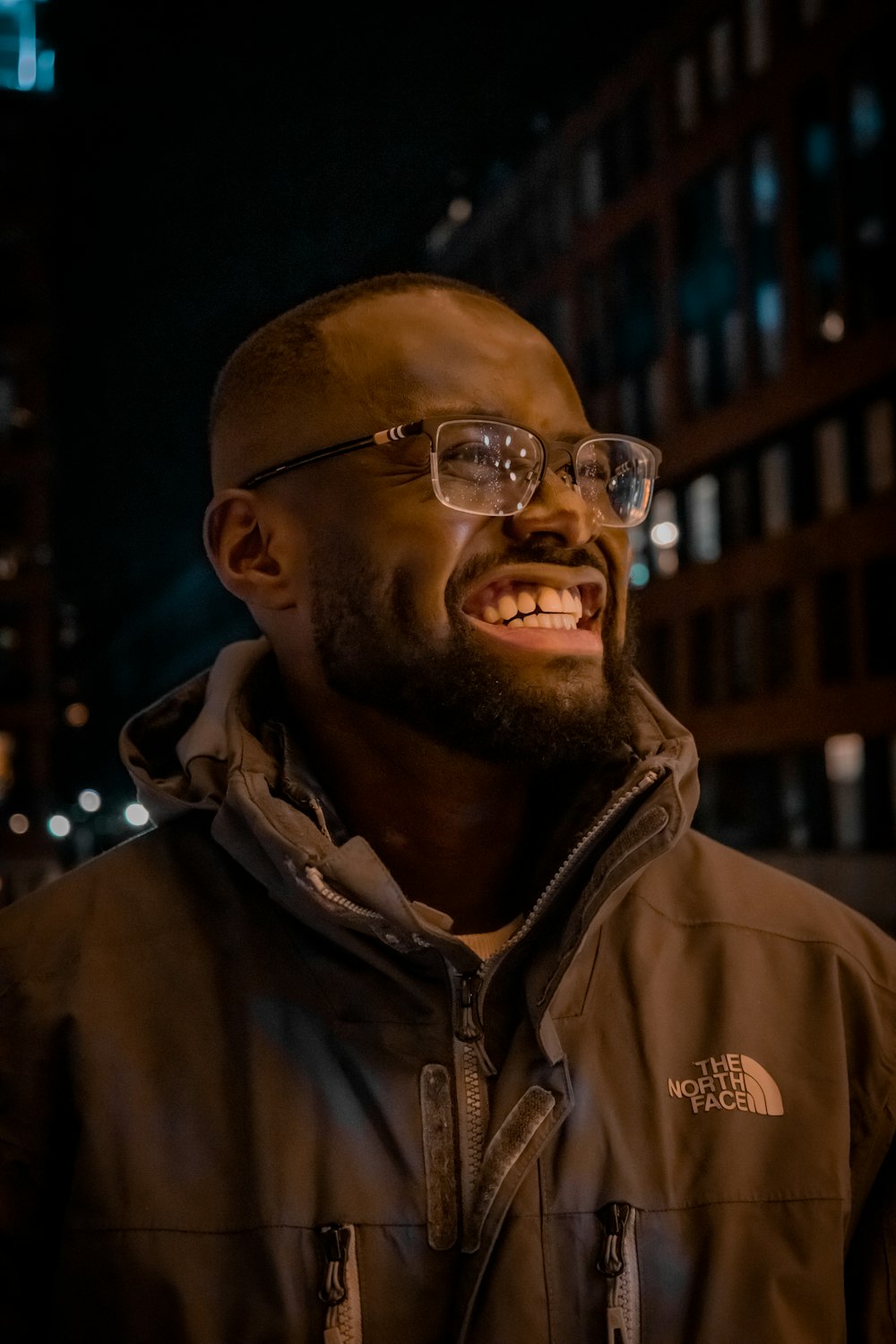 a man with a beard and glasses smiling