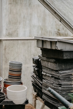 Stacks of plastic pots and pans collected from growers, prepared for recycling processing.