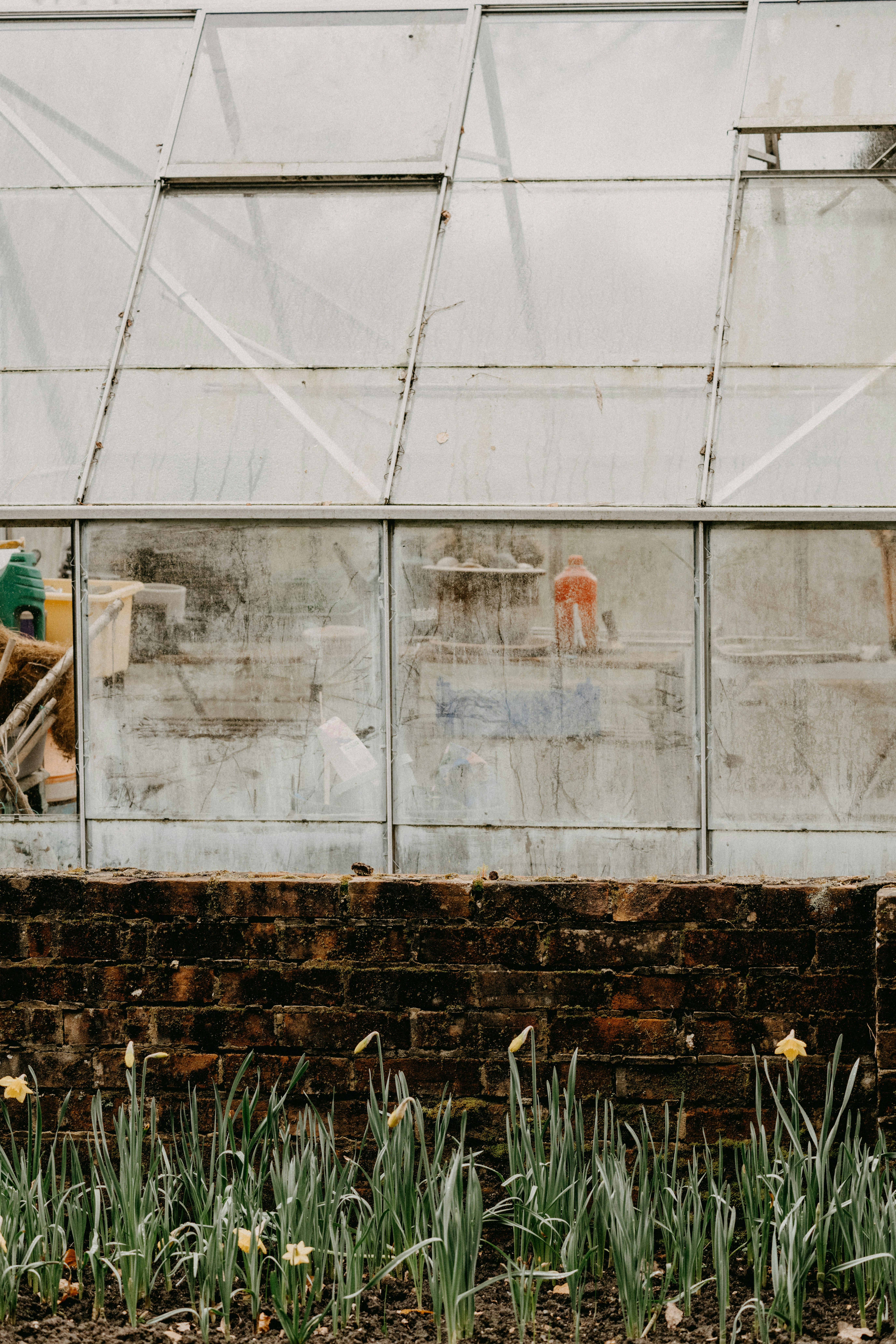a brick wall with graffiti on the side of it