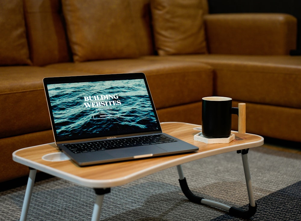 a laptop computer sitting on top of a wooden table