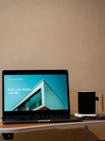 a laptop computer sitting on top of a wooden desk