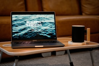 a laptop computer sitting on top of a wooden table
