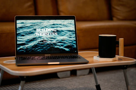 a laptop computer sitting on top of a wooden table