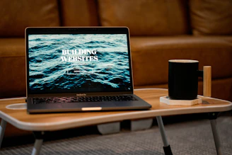 a laptop computer sitting on top of a wooden table