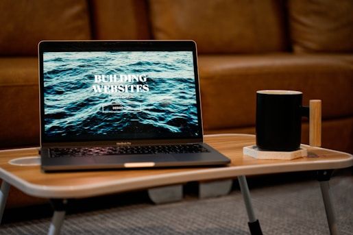 a laptop computer sitting on top of a wooden table