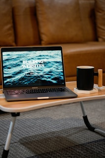 a laptop computer sitting on top of a wooden table