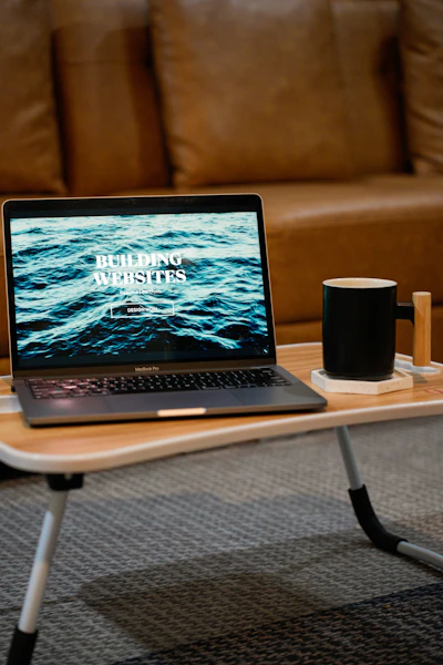 a laptop computer sitting on top of a wooden table