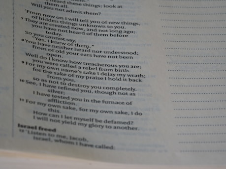 A close-up image of a page from a book containing printed text. The text includes lines that seem to be from a narrative or dialogue, with some words bolded or emphasized. The right side of the page features evenly spaced dotted lines.