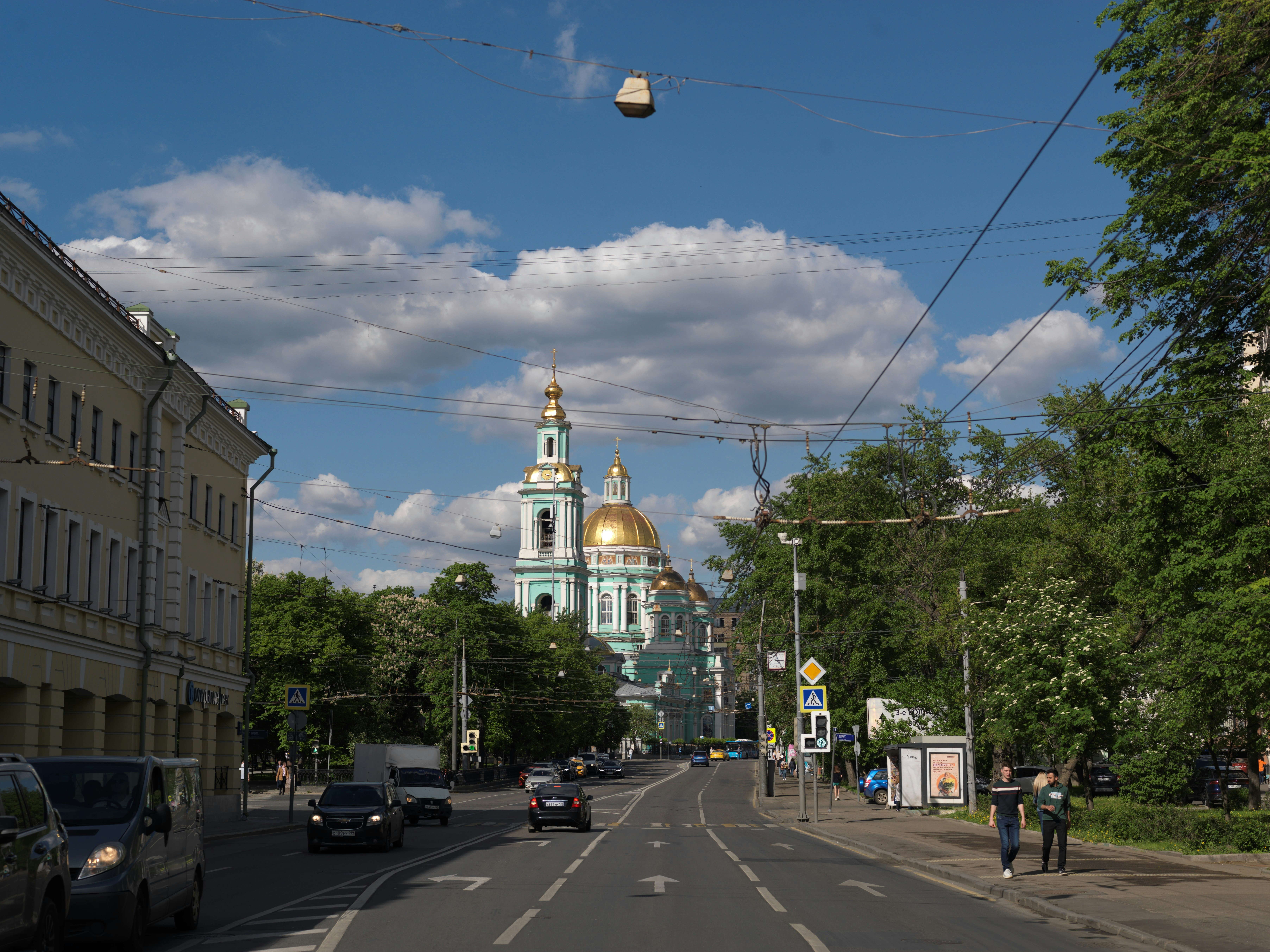 a city street with a church in the background