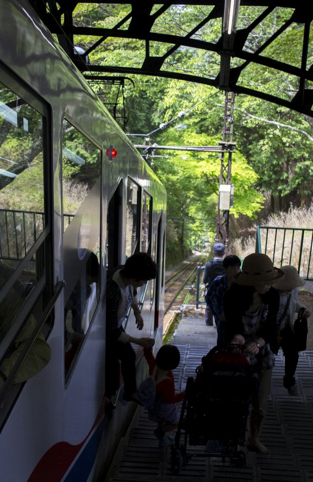 a group of people boarding a train at a station